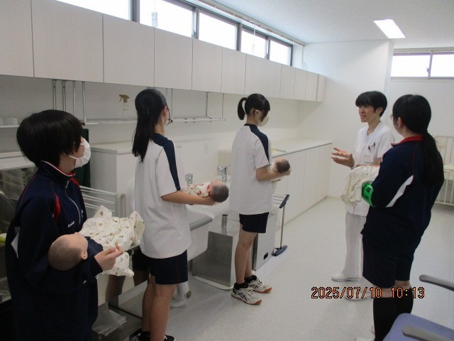 赤ちゃんの人形をだっこしています。